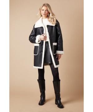 Luxurious shearling-style lining for ultimate warmth
        Oversized fit for effortless layering
        Contrasting patch pockets add a stylish touch
        Notched lapel collar for a classic look
        Long-line silhouette offers versatile styling options
    
    Embrace the chill with this striking bonded shearling coat from Oasis. The contrasting exterior and plush interior create a bold, eye-catching look that's perfect for making a statement on cooler days. Its relaxed fit allows for easy layering over your favourite jumpers and dresses, while the long-line silhouette provides ample coverage and warmth. Style it with slim-fit trousers and ankle boots for a chic daytime ensemble, or throw it over a floral midi dress for a pretty contrast at casual gatherings. The versatile design makes it an ideal choice for everything from weekend brunches to family outings. For a more polished look, cinch the waist with a statement belt to create definition and showcase your personal style.