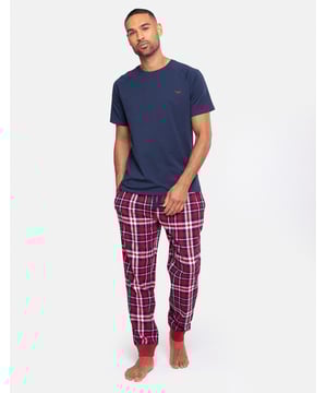 Lounge in comfort with this pyjama set from Threadbare. This set contains a short sleeve, round neck cotton t-shirt with Threadbare embroidery on the chest, and long cuffed pants in a flannel check with an elasticated waistband and branded drawcords. This set is super comfortable and perfect for lounging at home or bedtime.
