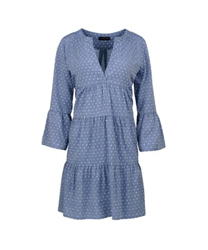 This dress with gathered seams is crafted in an embroidered denim style viscose which creates a polka dot effect.  It has ¾ bell sleeves and a round neckline with a 24cm V opening in the front. There is a press stud on the inside at the bottom of the V to prevent it opening too much. It has oblong shaped double fabric below the V opening in the front. The dress has two 24cm wide ruched panels. There is a double pleat in the back. This dress is styled in a loose A line silhouette and hits above the knee.