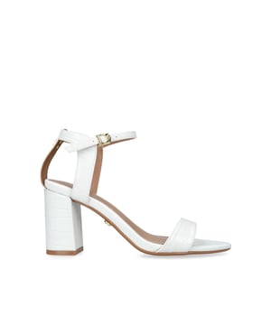 The Carvela Kiki is a block heeled sandal. The upper is in a bone snake embossed design with open toe. The ankle is fastened with gold tone buckle and features an Icon C stud. Heel height: 80mm