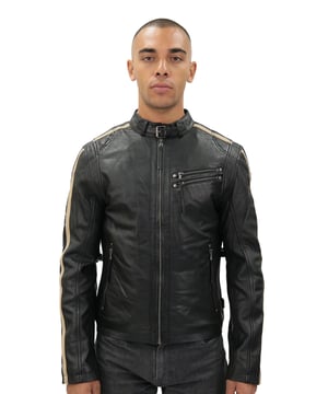 Diese moderne Interpretation des Café Racer hat seine stilistischen Wurzeln in den 70er Jahren und bietet eine frische Interpretation der ikonischen Jacke. Mit dem traditionellen kurzen Kragen mit Riegelverschluss und der Biker-Silhouette bleibt es dem Racer-Stil treu. Allerdings haben wir der Jacke mit den Le-Mans-Streifen, die vertikal über die Jackenärmel verlaufen, und einer doppelten Reißverschlusstasche auf der linken Brust eine ganz eigene Note verliehen. Abgerundet wird diese zeitgemäße Variante durch einen verstellbaren Bund und Reißverschlussbündchen zur individuellen Anpassung an die persönlichen Vorlieben sowie zwei funktionelle Reißverschlusstaschen an der Taille. • 100 % hochwertiges, ultraweiches Nappaleder. • Zwei Reißverschlusstaschen an der Taille und zwei Innenfächer • Streifen im Racing-Stil an jedem Jackenärmel • Durchgehender YKK-Reißverschluss auf der Vorderseite • Doppelte Reißverschlusstasche auf der linken Brust