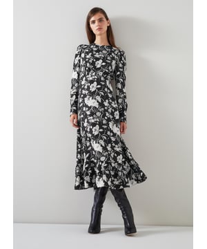 Embrace a night of elegance with the Winona mono meadow print jacquard dress. This black silk mix beauty features a sophisticated floral design, complete with back buttons, a zip, and a timeless crew neck. Pair it with your favourite heels or statement jewellery for a truly captivating look.