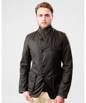 Barbour Beacon Sports Wax Jacket
As this is a slim fitting jacket, we would advise purchasing the next size up than you would normally choose. The three-pocket waxed Beacon Sports jacket is an iconic blazer-style button through, inspired by the sought-after, limited edition To Ki To Sports Jacket. Effortlessly stylish and easy to wear, the Beacon Sports Jacket is a mediumweight waxed cotton jacket featuring soft leather-bound cuff edges, shoulder and elbow patches, two zipped rear pockets and a button-up throat flap. Lined with Barbour tartan, this jacket reflects traditional Barbour elements, with classic hip-height bellows pockets and a single chest pocket. This jacket is surprisingly versatile, and looks great worn as a blazer with the collar folded down and lapels open, or with the collar turned up worn over a fine-knit jumper and scarf for a contemporary country look.

Tailored Fit
Barbour tonal embroidery to left pocket
Outer: 100% cotton (waxed)
Lining: 100% cotton
Trim: 100% wool
6oz waxed cotton
Do not wash
Sponge clean only
Back length: 69cm - 81.5cm

MWX0007