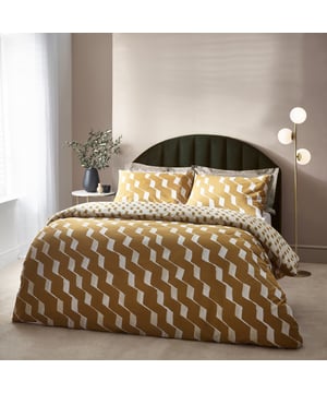 Inspired by modern, minimalist and abstract art, the Zabine duvet cover set has a contrast crimped ribbon pattern which lays casually across the design diagonally. Surrounded by a warm honey toned background, ideal for a modern, stylish neutral interior. The reverse features a smaller scale coordinating print and provides a lighter tone if a midweek refresh is in order. A timeless and modern addition to your bedding collection. This product is certified by OEKO-TEX® showing it has been sustainably made.