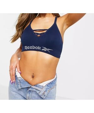 Reebok seamless performance sports bra top, knitted logos, elasticated under the bust, removable bust padding, adjustable shoulder straps, seamless construction for minimised rub and irritation.