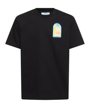 The T-shirt features a classic cut with a round neckline, offering a timeless silhouette. The front is graced with a vibrant, stylised print depicting an abstract representation of a window or gateway, bathed in the soft pastel hues of blue, yellow, and orange, evoking the serene beauty of a sunset. 
