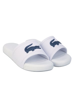 Children Boys Lacoste L.30 Slide Sandals in white blue.<BR><BR>- Synthetic upper.<BR>- Slip on construction.<BR>- Injection-moulded EVA outsole.<BR>- Large crocodile branding on the strap.<BR>- Bold colourways bring a strong aesthetic to the poolside.<BR>- Synthetic upper  Synthetic lining  Synthetic sole.<BR>- Ref: 741CUC0008X96