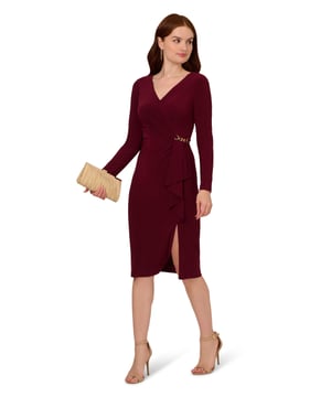 Make your biggest moments even more memorable when you step out in this long sleeve dress. This dress features a faux wrap silhouette, v-neckline, and long sleeves. Designed with ribbed jersey fabric that has tons of stretch, this midi dress has a draped detail at the waist and is accented by chain trim on both sides of the design. Elevated yet appropriate for every day, this jersey dress has a hidden zipper closure at the back and a slit at the skirt. From a day at the office to date night, this long sleeve dress will look lovely no matter the occasion.