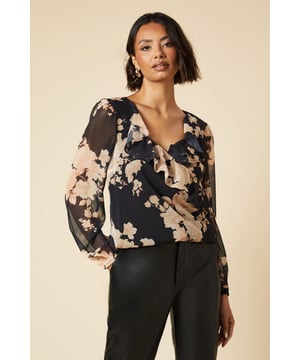 Enchanting floral print chiffon blouse
        Romantic sweetheart neckline with ruffle detail
        Elegant long sleeves with subtle volume
        Flattering wrap-style silhouette
        Versatile design suitable for various occasions
    
    Embrace effortless femininity with this captivating floral chiffon blouse from Dorothy Perkins. The sweetheart neckline adorned with delicate ruffles adds a touch of romance, while the long sleeves offer a graceful silhouette. Perfect for the woman who appreciates trendy yet modest fashion, this blouse is ideal for casual outings or family gatherings. Style it with tailored trousers and flats for a chic brunch look, or pair it with a pencil skirt for a baby shower. The wrap-style design flatters various body types, making it a versatile addition to your wardrobe. Whether you're meeting friends for coffee or attending a casual work event, this blouse will ensure you look polished and put-together without compromising on comfort.