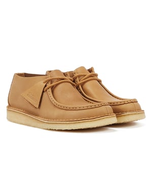 Introducing the Nomad shoe, a fusion of Wallabee and Desert Trek styles, boasting hand-stitched details. Crafted from premium mid tan leather upper for durability and style. Finished with a lightweight pebble crepe sole for added comfort and traction.