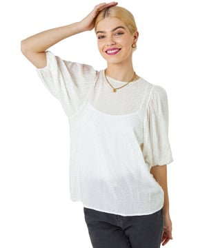 Glitter Spot Balloon Sleeve Top from Roman. Want a sparkly updated piece to add to your wardrobe? Look no further than our spot print woven top. Featuring a round neckline with glitter trim detail, 3/4 length puff sleeves with elasticated cuffs and all over glitter spot print. Style this round neck top with your favourite trousers and heels for a desk to dinner ensemble, or dress it down with cropped trousers and sandals for a light and breezy summer look in the city.
