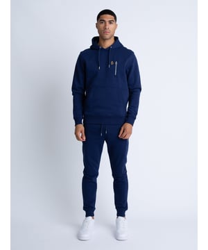 This tracksuit from LUKE is sure to keep you looking cool and feeling comfortable. Both the hoodie and joggers are cut from a soft cotton mix fabrication and detailed with ribbed trims. They are both completed with the brands iconic lion head embroidery. Iconic LUKE BLACK, GOLD, RED lion head embroidery. Iconic LUKE tri-colour trim tape. Chrome trims. Chest zip pocket detail. Ribbed cuffs and hem on the hoodie. Ribbed waist and cuffs on the joggers