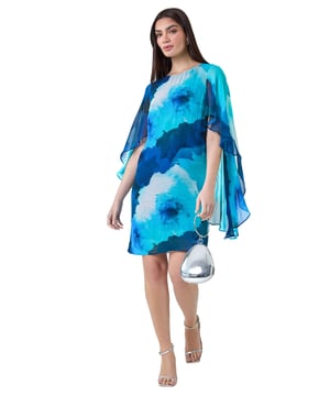 Floral Print Chiffon Cape Shift Dress from Roman. Make a statement this season in our elegant, Ariella collection chiffon cape dress. This stunning piece is perfect for those special events with its modest round neckline and secure zip fastening. The whimsical cape sleeves add a touch of drama to the classic shift shape, while the beautiful floral print exudes femininity. The draped chiffon fabric floats gracefully as you move, making you feel like a true belle of the ball! Whether you're attending a wedding or a formal dinner, style with strappy heels and a clutch bag for a look that's sure to turn heads!