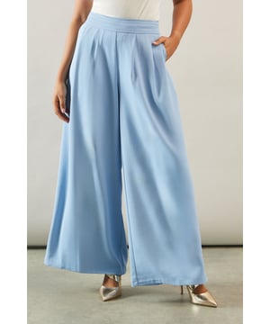Fluid wide-leg design for effortless movement
        High-waisted silhouette for a flattering fit
        Sleek side pockets for practicality
        Versatile length suitable for various heights
        Smooth, draping fabric for a polished look
    
    Embrace sophistication with these fluid wide-leg trousers from Wallis. Perfect for the woman who appreciates glamour without compromising on comfort, these trousers offer a versatile addition to your smart wardrobe. The high-waisted design elongates your silhouette, while the wide-leg cut provides a graceful drape that moves beautifully with every step. Style them with a crisp white blouse and blazer for a refined office ensemble, or pair with a silky camisole and statement jewellery for elegant evening attire. These trousers transition seamlessly from day to night, making them ideal for smart-casual events or occasions where you want to project a formal, put-together image. The fluid fabric ensures all-day comfort, allowing you to feel as good as you look, whether you're attending a business meeting or enjoying a sophisticated dinner out.