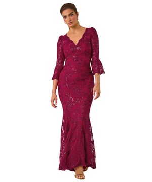 Lace Scallop V-Neck Bodycon Maxi Dress from Roman. Feel elegant and sophisticated in our stunning lace bodycon maxi dress, perfect for the Autumn Winter season. The feminine v-neckline is adorned with delicate scalloped lace details for a touch of romance. Designed in a flattering bodycon shape, this dress is crafted and lined from a comfortable woven fabric, finishing at maxi length with long sleeves to keep you warm at your next special occasion. Style with heels and a bolero for a truly unforgettable outfit!