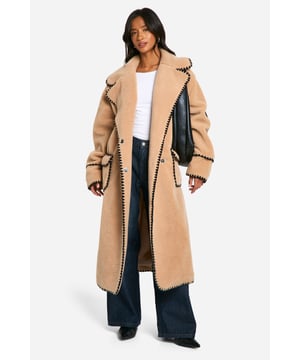 Oversized longline silhouette for maximum cosiness
        Plush borg fabric for ultimate comfort and warmth
        Contrasting whipstitch trim for a distinctive edge
        Roomy patch pockets for practicality and style
        Wide lapel collar adds a touch of sophistication
    
    Wrap yourself in luxurious comfort with this statement teddy jacket. Perfect for those chilly days when you want to make a fashion-forward impression, this coat combines style and cosiness effortlessly. The oversized fit allows for easy layering, making it ideal for casual outings or relaxed weekend brunches. Pair it with wide-leg jeans and a simple white tee for an effortlessly chic look, or throw it over a jumper dress and boots for a cosy yet put-together ensemble. The versatile nature of this jacket makes it a go-to choice for family gatherings, casual meet-ups with friends, or even a laid-back date night. Its ability to elevate any outfit while providing warmth makes it an essential addition to your autumn and winter wardrobe.