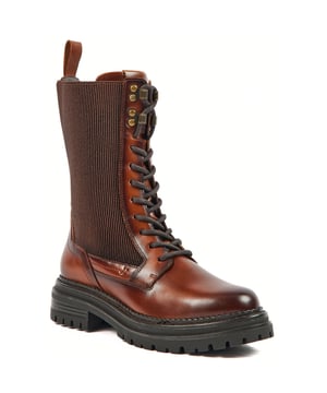 Der Leder-Kampfstiefel POLLY verbindet praktischen Stil mit einem Hauch von Glamour. Er ist aus hochwertigem Leder gefertigt, hat eine Gummisohle und verfügt über Schnürsenkel an der Vorderseite sowie seitliche Reißverschlüsse.