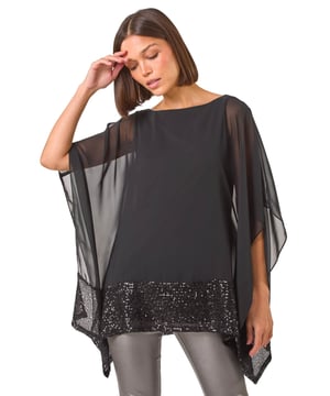 Sequin Contrast Top from Roman. Get ready to sparkle and shine in this stunning sequin contrast top. Crafted from delicate georgette fabric, this top features a glitzy sequin hem that adds a touch of glamour. With elegant 3/4 sleeves and a classic round neck, this top is perfect for special occasions this Autumn/Winter. Style with pleather trousers and heeled boots for a party ready look that will make you stand out from the crowd!