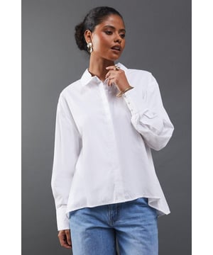 Striking open back design with tie detail
        Classic collared neckline for a polished look
        Long sleeves with button cuffs for versatility
        Relaxed fit through the body for comfort
        Crafted from breathable cotton poplin fabric
    
    Make a statement with this eye-catching poplin shirt from Warehouse. The open back design with delicate tie detail adds an unexpected twist to a classic silhouette, perfect for those who want to inject a bit of edge into their wardrobe. The relaxed fit and breathable cotton fabric ensure all-day comfort, while the collared neckline maintains a smart appearance. Style this versatile piece with your favourite denim for a casual daytime look, or dress it up with tailored trousers for a chic ensemble suitable for family gatherings or brunch with friends. The long sleeves can be rolled up for a more relaxed vibe, making this shirt adaptable for various occasions. Pair with flat sandals or trainers to complete your effortlessly cool outfit.