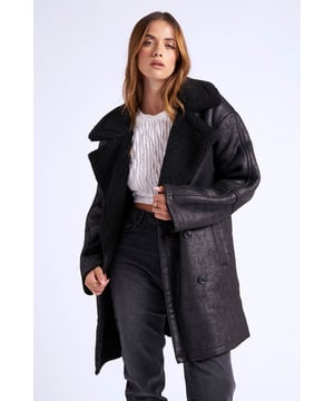 Model is 5'6 and wears a size 8. Mid Length. Borg Lining. Bonded. This mid-length bonded coat offers the perfect balance between modern style and timeless sophistication. Its versatile length provides an elegant touch suitable for various occasions, adding a contemporary flair to any outfit.