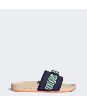 Rules are made to be broken. So are style conventions. You can smash both in the adidas Pouchylette Slides. Comfortable shoes that you can wear absolutely anywhere, they have a pouch on top of one shoe — because why not? The best part is the bold style that is always original. Always authentic. Always you.Made in part with recycled content generated from production waste, e.g., cutting scraps, and post-consumer household waste to avoid the larger environmental impact of producing virgin content.  - Slip-on - Textile upper - Zip pouch pocket on strap - Textile lining - Synthetic outsole - 25% of the components used to make the upper are made with a minimum of 50% recycled content  Shipped by adidas