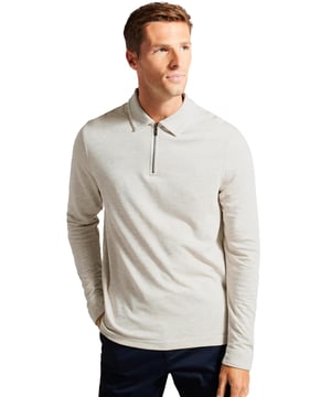 The Ted Baker men's Karpol long sleeve polo shirt in navy offers a refined take on a wardrobe staple. Crafted from a soft modal blend fabric, this polo delivers exceptional comfort and a luxurious feel against the skin. It features a classic collar and a zip placket, adding a modern twist to the timeless design. The long sleeves make it a versatile piece, suitable for both casual and smart-casual looks, providing style and ease for any occasion.
