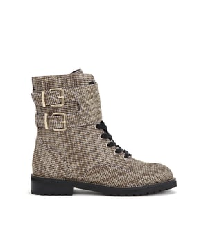 The Sutton ankle boot arrives in a beige houndstooth fabric topped with gold crystal embellishment. The front is laced up with two gold tone buckled ankle straps. Heel height: 3cm.
