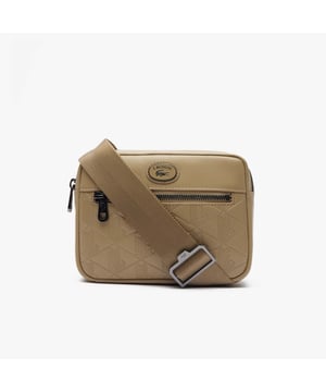 Leather Monogram Print Vertical Satchel.- Dimensions: L5.9 x H8.3 x D2 in.- L15 x H21 x D5 cm.- Exterior in split calfskin leather.- Adjustable strap: 75cm - 140cm - 29.5 - 55 in.- 1 zipped pocket on outside, 1 mesh patch pocket on inside.- Enamel plaque with crocodile logo. Material: 100% Polyurethane. Ref: NH4486MRC87.