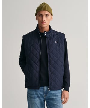 Crafted in a diamond quilting structure, this Quilted Windcheater Vest features recycled polyester padding and is treated with a water-repellent finish. Design details include a one-way zipper at the front, snap buttons at the collar, slanted welt side pockets and an elasticated hem and cuff with a press button adjuster.
Regular fit  Above hip length  Diamond quilting  Water-repellent 
&nbsp;
Shell - Polyester 100%Lining - Polyester 100%Padding - Recycled Polyester 100%
&nbsp;
7006341
&nbsp;
&nbsp;
