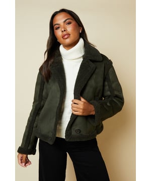 Cropped aviator-style jacket with suede-like finish
        Plush shearling-effect collar and lining for warmth
        Double-breasted front with button fastenings
        Relaxed fit with dropped shoulders for easy layering
        Side pockets for practicality and style
    
    Embrace the cool-weather season with this chic suede cropped aviator jacket from Dorothy Perkins. Perfect for the fashion-forward woman who values both style and comfort, this versatile piece is ideal for casual outings and family gatherings. The jacket's cropped silhouette adds a modern twist to the classic aviator style, while the plush shearling-effect details provide cosy warmth. Style it as seen on the model with a crisp white turtleneck, wide-leg trousers, and chunky boots for a trendy brunch look. Alternatively, throw it over a floral midi dress and ankle boots for a charming baby shower ensemble. The relaxed fit allows for easy layering, making it a go-to choice for unpredictable British weather. Whether you're meeting friends for coffee or running weekend errands, this jacket will keep you looking effortlessly stylish and feeling comfortable all day long.