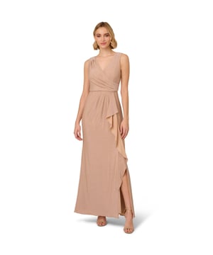 A glamorous evening out is guaranteed when you step into this sleeveless mermaid gown. This formal dress features a sleeveless surplice bodice with v-neckline, pleated details from shoulder to waist, and draping from the waist that flanks the slit at the side of the mermaid skirt. Designed from a metallic knit fabric, this evening gown subtly sparkles with every movement. A hidden zipper closure at the centre back completes this sleeveless dress. Paired with nude heels and a bold clutch, this metallic dress is the perfect choice for formal weddings or black-tie affairs.