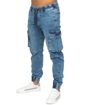 Enzo Mens Elasticated Waist Stretch Cuffed Jeans. Features a 5 Pocket Design. 2 Slash Pockets, 1 Back Pocket 2 Front Cargo, Bellow Side Pockets With Velcro Fastening. Elasticated Waist With Adjustable Drawstings. Cut and Sew Design On Leg. Cuffed Ankle