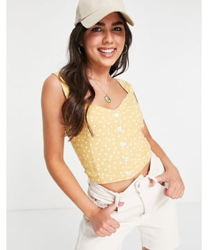 Cute top,  
Button placket,  
Adjustable straps,  
Shirred, stretch back panel,  
Cropped length,  
Slim fit