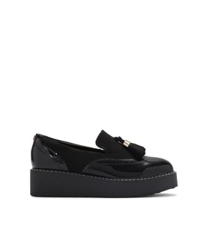 This  KG Kurt Geiger   More slip on loafer is in a modern flatform style. There is a patent detail across the toe and heel. The vamp features microsuede tassels.