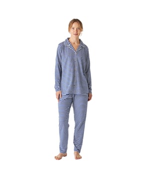 Pijama de mujer de manga larga con un diseño elegante y cómodo, ideal para descansar o relajarse en casa.

Su diseño moderno y sofisticado se adapta perfectamente a la figura femenina, realzando la silueta con un estilo chic y relajado.

El conjunto incluye una parte superior de manga larga que cuenta con un práctico cierre de botones, añadiendo funcionalidad y un detalle de estilo.

El pantalón largo tiene un ajuste holgado y una cintura elástica ajustable mediante cordones para mayor comodidad. Además, incluye prácticos bolsillos laterales, perfectos para llevar pequeños objetos o simplemente para añadir un toque funcional al diseño

Toda la pijama está confeccionada en algodón, un material suave y transpirable, perfecto para cualquier época del año, garantizando frescura y confort durante el descanso.
 Composición: Camiseta: 100% Algodón; Pantalón: 100% Algodón
 Cuidados:
- Lavado a máquina en frío y en ciclo suave para evitar el desgaste de las fibras.
- No usar lejía o blanqueadores
- Secar al aire libre o en secadora a baja temperatura para evitar que se encoja o pierda su forma.
- Planchar a temperaturas bajas.