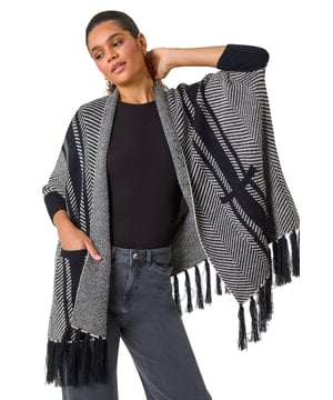 Abstract Print Knit Coverup from Roman. Make a statement with this patterned knit cover up for the upcoming Autumn/Winter season. Boasting long sleeves and an intricate pattern, this cover up features a fun fringe hem detail for a touch of flair. The applied front pockets add both style and function to this cosy piece. Pair it effortlessly with a simple t-shirt and your favourite jeans for a chic and casual look!