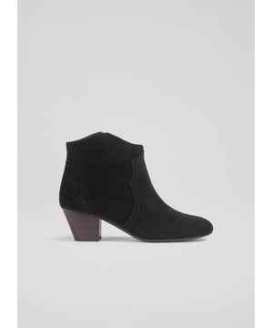 Embrace timeless elegance with the Leida ankle boots, perfect for any casual occasion. These black suede boots feature an almond toe and sturdy wood stacked heel, lined with leather for lasting comfort. Pair these western boots effortlessly with skinny jeans or a flowing midi skirt for a polished look. Made in Spain.