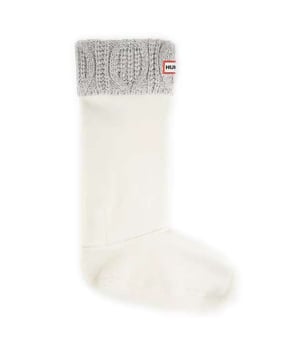 Hunter Original Cable Cuff Tall White Boot Socks are a stylish and practical accessory designed to complement your Hunter boots. With a cable cuff pattern and a crisp white color, these socks add a touch of sophistication to your rainy-day attire while providing additional warmth and comfort.

Key Features:

 Cable Cuff Design:  The cable cuff pattern adds a classic and timeless touch to these tall boot socks, enhancing the overall aesthetic and creating a fashionable look.

 White Color:   The white color offers a clean and versatile option, allowing these socks to pair seamlessly with various Hunter boot styles and different outfits.

 Tall Boot Length:   Tailored for tall Hunter boots, these socks provide extended coverage above the boot's shaft, delivering both warmth and a stylish detail.

 Premium Material:   Crafted from high-quality materials, the socks offer a soft and comfortable feel against your skin, ensuring a pleasant wearing experience.

 Iconic Branding:   Look for the subtle Hunter logo or branding on the sock, reflecting the authenticity and quality associated with the Hunter brand.

 Warmth and Insulation:   Ideal for cooler weather, the cable cuff socks provide additional insulation, keeping your feet warm and cozy even in colder temperatures.

 Ribbed Cuff:   The ribbed cuff ensures a secure fit and adds a stylish detail to the top of the socks, preventing them from slipping down during wear.

Styling Tips:

Showcase the cable cuff pattern by letting the socks peek out just above the boot's shaft, adding a chic and textured element to your overall look.

Pair these Cable Cuff Tall White Boot Socks with your favorite Hunter boots for a coordinated and fashionable ensemble, especially during rainy or colder seasons.
