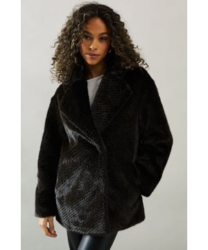 Luxurious two-tone faux fur design
        Oversized lapels for a dramatic look
        Relaxed fit for comfortable layering
        Long sleeves with turn-up cuffs
        Versatile length suitable for various outfits
    
    Make a statement with this sumptuous two-tone faux fur coat from Wallis. Perfect for those who appreciate glamour and sophistication, this coat offers both style and comfort. The oversized lapels create a dramatic silhouette, while the relaxed fit allows for easy layering over your favourite ensembles. Ideal for smart casual events or when you want to add a touch of elegance to your look, this coat can be dressed up or down with ease. Pair it with a sequin dress and strappy heels for a night out, or wear it over tailored trousers and a crisp white blouse for a refined daytime appearance. The versatile length makes it suitable for various occasions, ensuring you'll always look polished and put-together. This Wallis coat is the perfect addition to your wardrobe, offering warmth and style in equal measure.