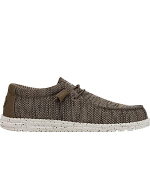 Step into unbeatable comfort with the Hey Dude Wally Sox, designed to keep you feeling light on your feet all day long. The woven polyester upper with a knit texture offers a breathable yet sturdy fit, while the elastic laces provide the convenience of easy slip-on, slip-off wear. Built on a lightweight, flexible EVA foam outsole, these shoes provide superior cushioning and flexibility. The removable foam insole adds extra comfort, making them ideal for long days or travel. Plus, they're easy to clean, ensuring your Wally Sox always look and feel fresh.- Textile upper- Slip-on wear- Comfort footbed- Durable outsole- Hey Dude branding