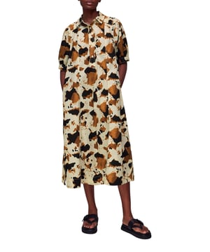 Embrace the statement look with our Cow Print Midi Shirt Dress, perfect for daytime flair or a casual weekend ensemble.