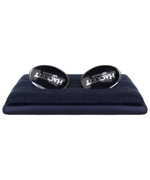 Hackett Oval Logo Men's Black Cuff Links, a fusion of classic design and contemporary sophistication. These meticulously crafted cuff links boast key features that set them apart as a must-have accessory for the discerning gentleman.

 Timeless Oval Design: The cuff links feature a classic oval shape, embodying timeless elegance that seamlessly complements any dress shirt or formal ensemble. The silhouette is thoughtfully designed for a refined and versatile look.

  Sleek Black Finish: Imbued with understated luxury, the sleek black finish of these cuff links adds a touch of modernity while maintaining a sense of sophistication. This versatile color ensures they pair seamlessly with a variety of suits and shirt styles.

 Embossed Hackett Logo: A mark of distinction, the iconic Hackett logo is expertly embossed on each cuff link. This subtle yet recognizable detail showcases the brand's commitment to quality and sartorial excellence, adding a touch of prestige to your ensemble.

 High-Quality Construction: Crafted from premium materials, these cuff links are a testament to Hackett's dedication to quality craftsmanship. The smooth and polished surface reflects attention to detail, while the durable construction ensures long-lasting wear.

 Secure Fastening Mechanism: The cuff links feature a secure and user-friendly fastening mechanism, providing ease of use while ensuring that they stay in place throughout your busy day or evening. This practical design element enhances both functionality and comfort.

 Versatile Styling: Whether you're dressing up for a formal event or adding a touch of sophistication to your everyday attire, these cuff links effortlessly transition from boardroom to black-tie affair, making them a versatile and indispensable accessory.