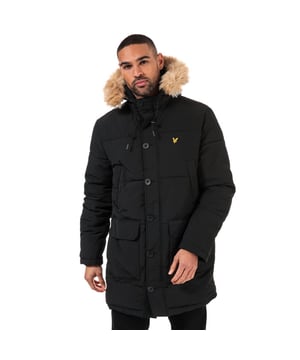 Mens Lyle And Scott Long Puffer Jacket in jet black.- Fixed hood with detachable faux fur trim and bungee-adjustable drawcord.- Full zip fastening with buttoned storm placket.- Long sleeves with inner ribbed cuffs.- Chest pockets with warm microfleece lining and snap closure.- Dual entry patch pockets to front.- Inner pockets.- Embroidered eagle logo at left chest.- Durable nylon construction.- Fully lined.- Shell: 100% Nylon.  Body lining: 65% Polyester  35% Cotton.  Sleeve lining: 100% Polyester.  Trim: 45% Acrylic  45% Modacrylic  10% Polyester.  Wadding: 100% Polyester.  Wipe clean only.- Ref: JK1320VZ865