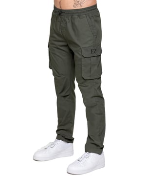 Upgrade your everyday style with the Enzo Men's Cargo Pants. Crafted from premium stretch fabric, these lightweight trousers offer a tapered leg fit for a sleek, modern look. Featuring an elasticated waistband with an adjustable toggle, they provide a customizable fit, while the adjustable toggle ankles let you tailor the look and feel. With two side slash pockets, two cargo pockets with secure Velcro fastening, and a single back welt pocket, you’ll have ample storage for essentials. Finished with an Enzo print on the cargo pocket. (649)
