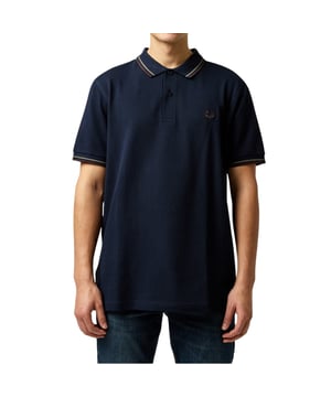 The Twin Tipped Fred Perry Polo Shirt by Fred Perry is a short sleeved polo shirt that has been made from Fred Perry's classic cotton piqué, in a contemporary adaptation of Fred's famous streamlined fit. Available in a diverse range of colourways - each with their own unique story. Featuring the signature Fred Perry wreath logo to the chest and twin tipping to the collar and cuffs.