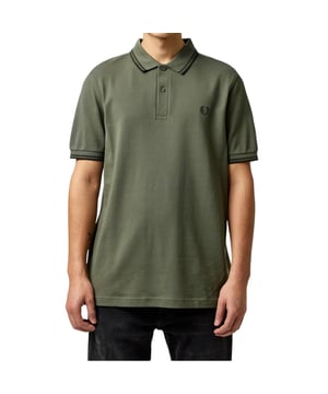 The Twin Tipped Fred Perry Polo Shirt by Fred Perry is a short sleeved polo shirt that has been made from Fred Perry's classic cotton piqué, in a contemporary adaptation of Fred's famous streamlined fit. Available in a diverse range of colourways - each with their own unique story. Featuring the signature Fred Perry wreath logo to the chest and twin tipping to the collar and cuffs.