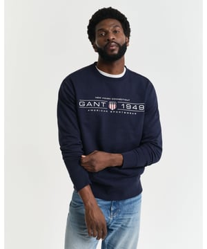 This GANT sweatshirt, made entirely of a soft cotton blend, offers both comfort and style. Designed with a regular fit, it features a classic crew neck, ribbed detailing at the cuffs and hem and a GANT graphic printed on the chest for a vintage look.
 

Regular fit
Crew neck
Ribbed hem, neck and cuffs
GANT graphic printed at chest

 
 80% Cotton, 20% Polyester (Recycled Fibres) 

2044016