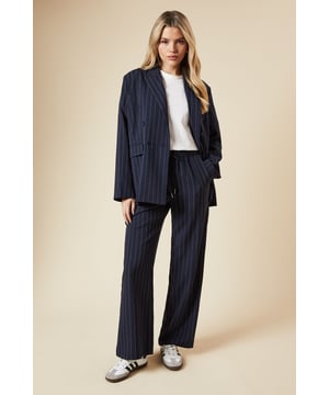 Elasticated waistband for comfort and ease
        Wide leg silhouette for a relaxed, on-trend look
        Vertical pinstripe pattern elongates the figure
        Side pockets for practicality
        Versatile length suitable for various heights
    
    Embrace effortless style with these Dorothy Perkins wide leg trousers. The elasticated waist ensures all-day comfort, perfect for those busy days running errands or meeting friends for a casual brunch. The pinstripe pattern adds a touch of sophistication, making these trousers easily dressed up or down. Pair with a crisp white t-shirt and trainers for a relaxed weekend look, or team with a blouse and ballet flats for a smart-casual office ensemble. The wide leg cut is not only on-trend but also flattering for various body types. These trousers are ideal for family gatherings or casual outings where you want to look put-together without sacrificing comfort. The versatile design makes them a wardrobe staple that you'll reach for time and time again.