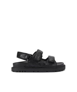 The Carvela Rosa Sandal is crafted in a black leather alternative. There is overstitch quilting in a diamond style across the upper straps. There is a gunmetal branding detail on the top strap.