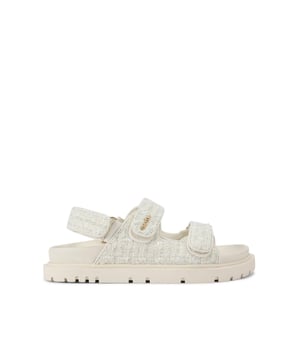 The Carvela Rosa Sandal is crafted in a cream tweed fabric. There is overstitch quilting in a diamond style across the upper straps. There is a gold branding detail on the top strap.